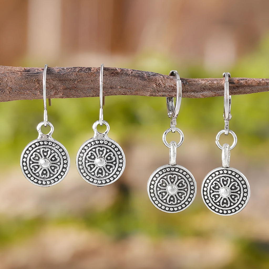 A pair of geometric zinc alloy earrings with a round distressed ethnic print in Bohemian retro style.