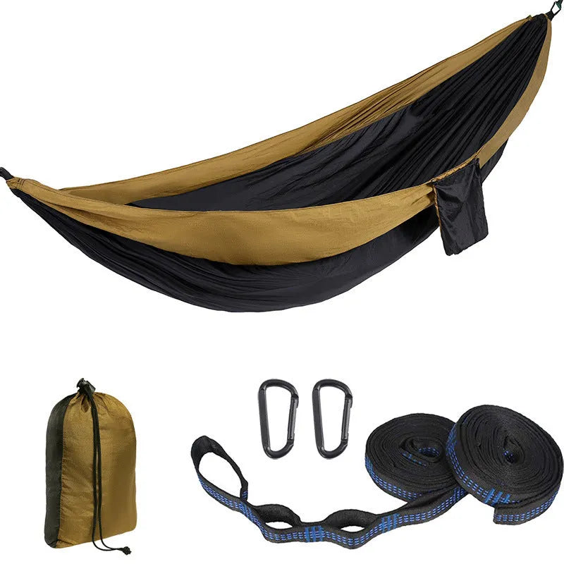 Double camping hammock with ropes and buckles shown in outdoor setting