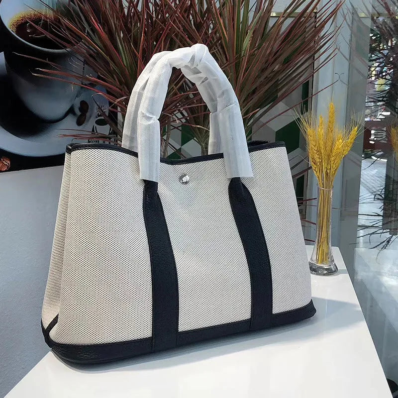 Genuine leather women's crossbody tote bag with canvas texture in bucket shape