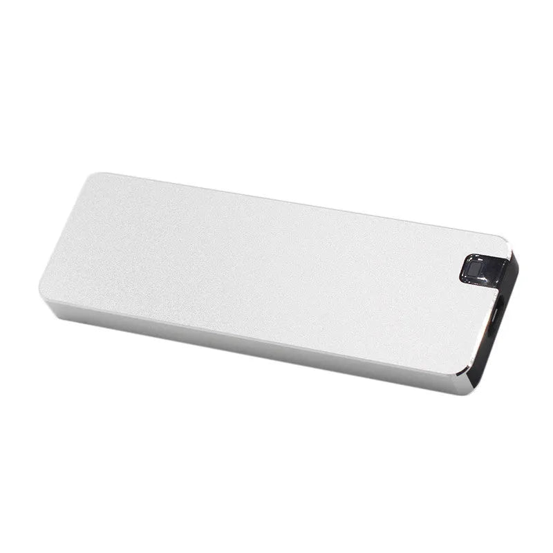 White metal portable external SSD hard drive with USB cable on a grey background