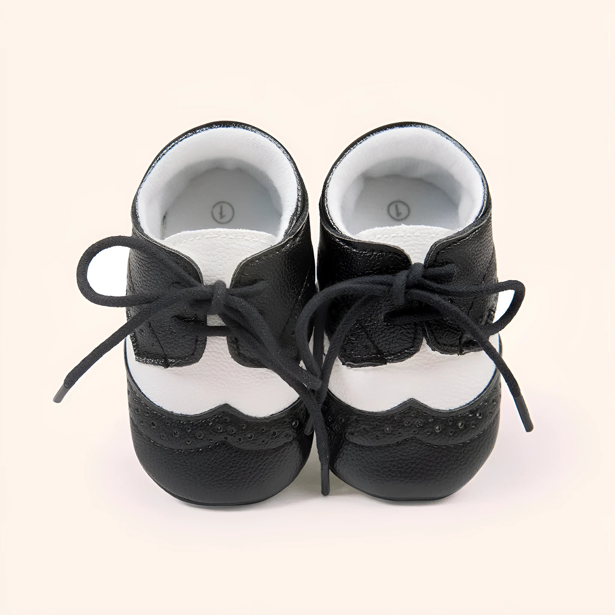 Vintage style soft-soled baby shoes for boys in synthetic leather, available in black, grey, light brown, and white.