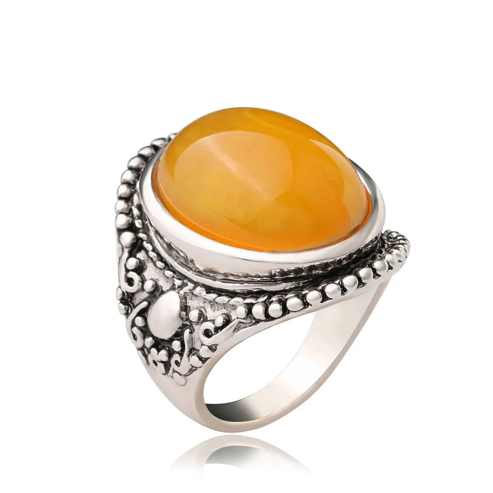 Geometric antique silver ring with fluorescent beeswax amber centre in retro style