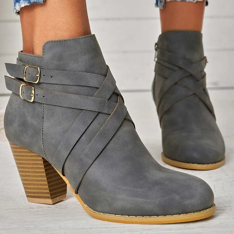 Women's grey PU leather ankle boot with a 7cm heel, side zipper, and belt buckle.