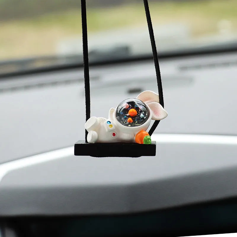 Resin cartoon astronaut car pendant available in red flag, telescope, and radish holding styles for dashboard decoration.