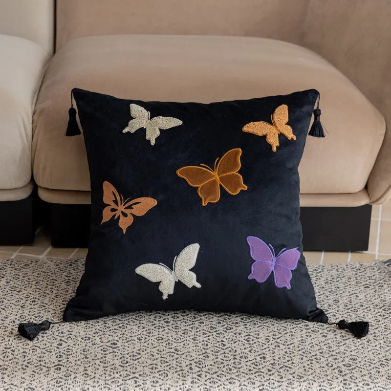 Square beige cushion with detailed black butterfly embroidery in a Chinese style pattern.