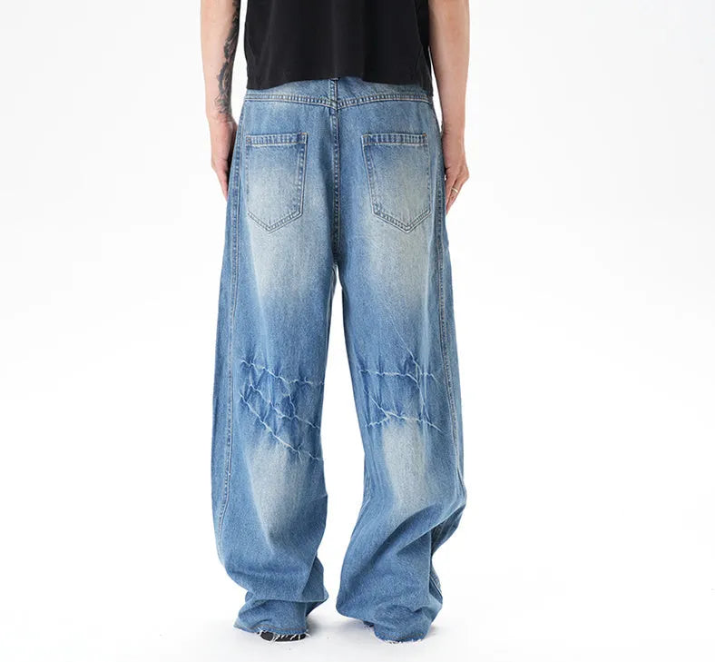 Light blue vintage wash wide leg denim jeans on a model, showing the relaxed fit and zip fly.