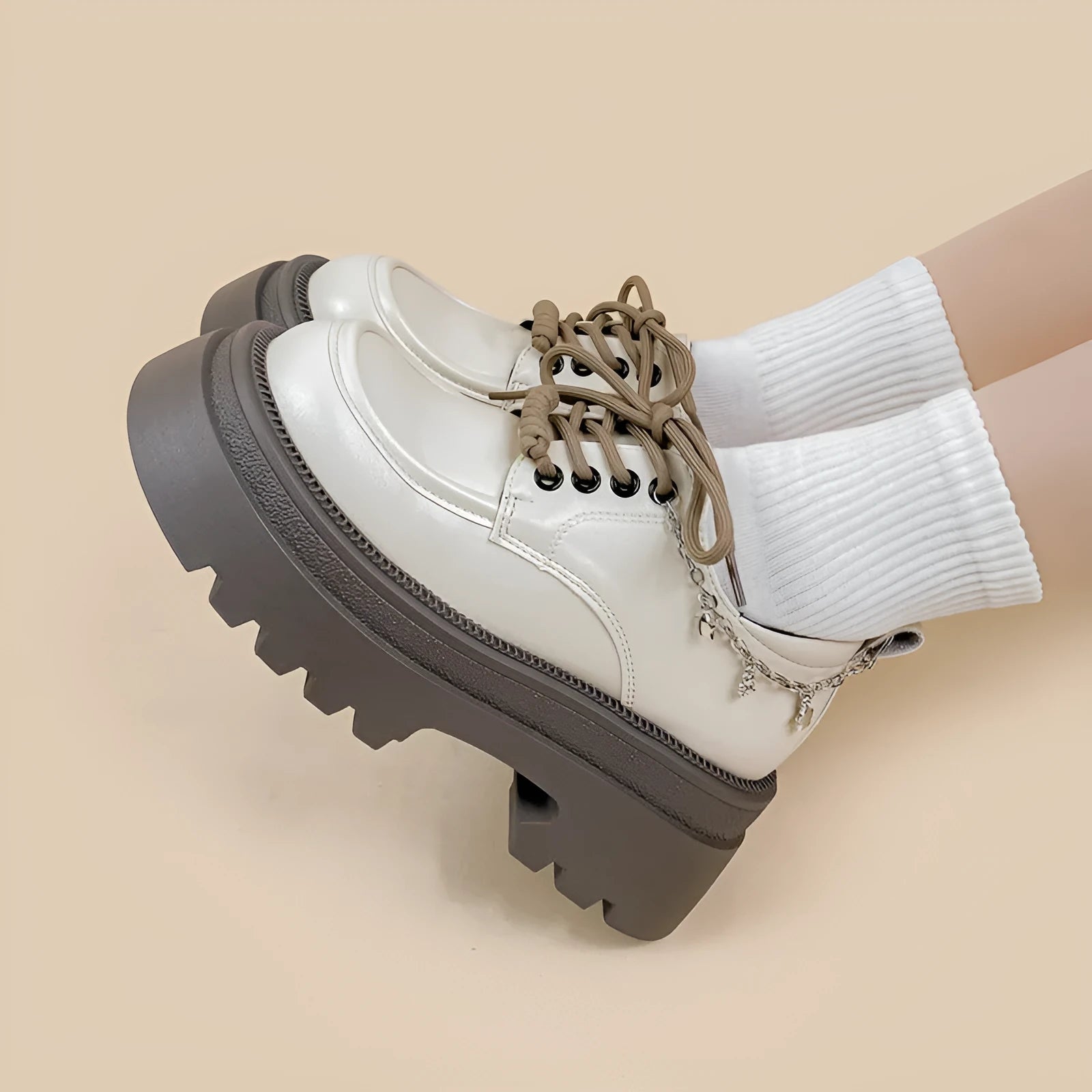White platform Mary Jane shoes with chunky heel and metal decorations on display