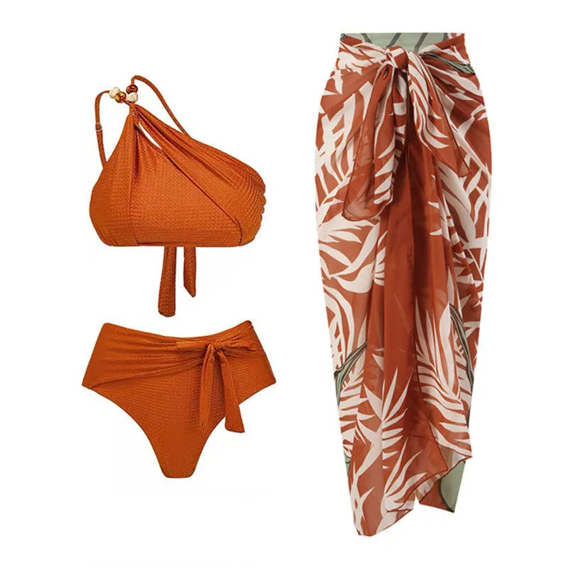 Brown high waist bikini with padded halter top and a sheer black chiffon overdress on a mannequin.