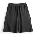 Heavy gray polyester sports shorts with straight leg design and elastic waistband