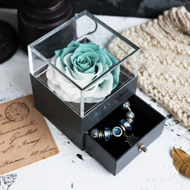 Eternal Flower gift box with preserved roses and carnations inside, measuring 8.5 cm square by 10.5 cm high