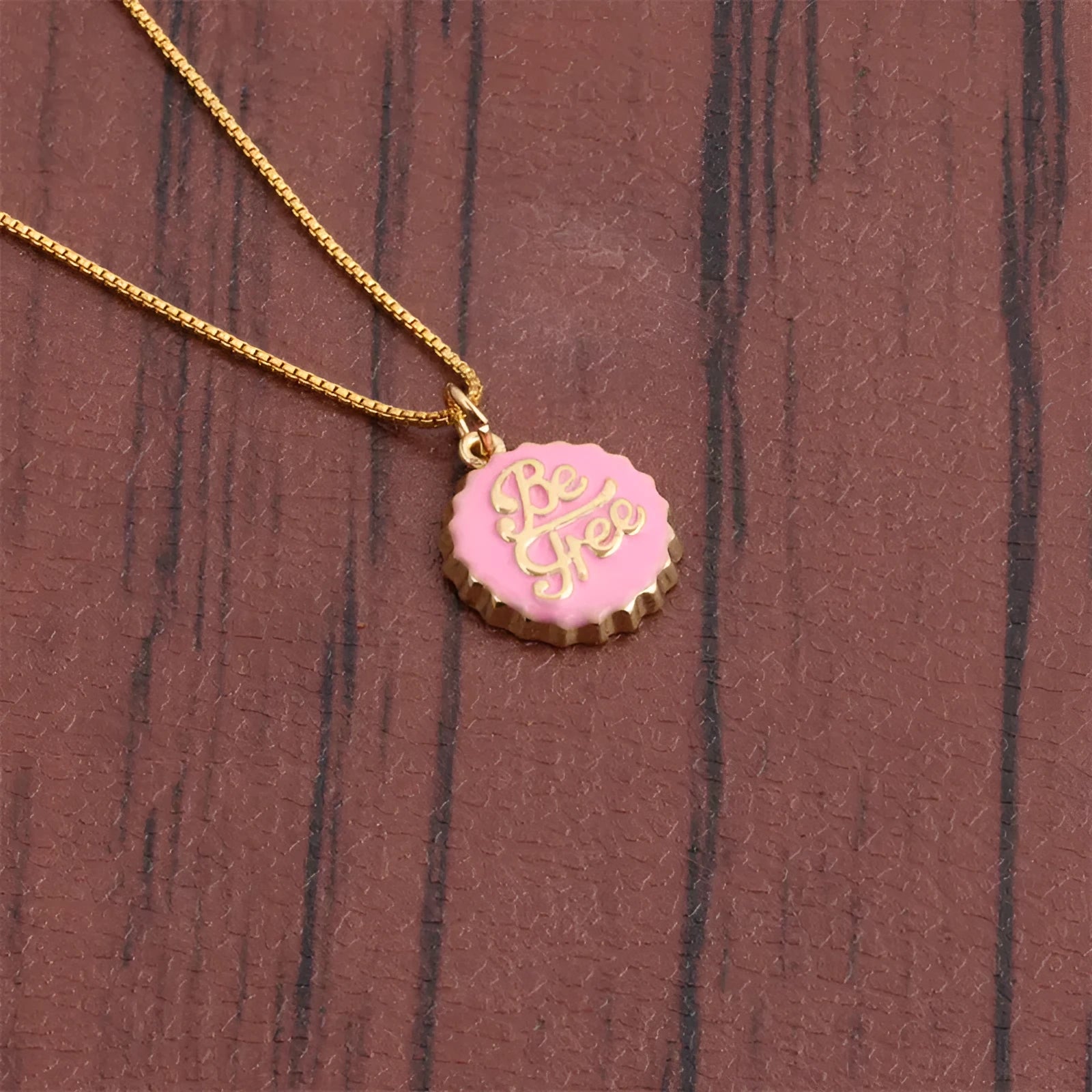 Copper bottle cap pendant necklace with gold plating on a 40cm box chain.