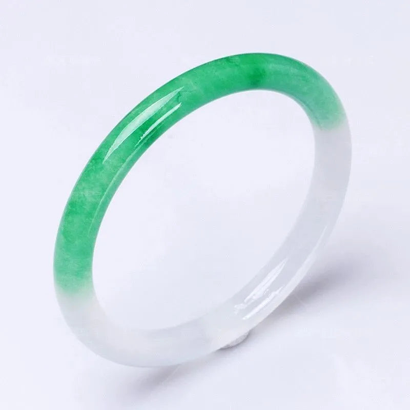 Jade bracelet with floating flower design and auspicious cloud patterns in ice-like emerald finish