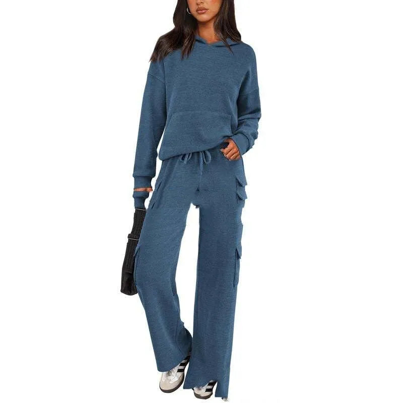 Women's two-piece leisure sports suit in polyester, showing long sleeve top and trousers in a solid colour.
