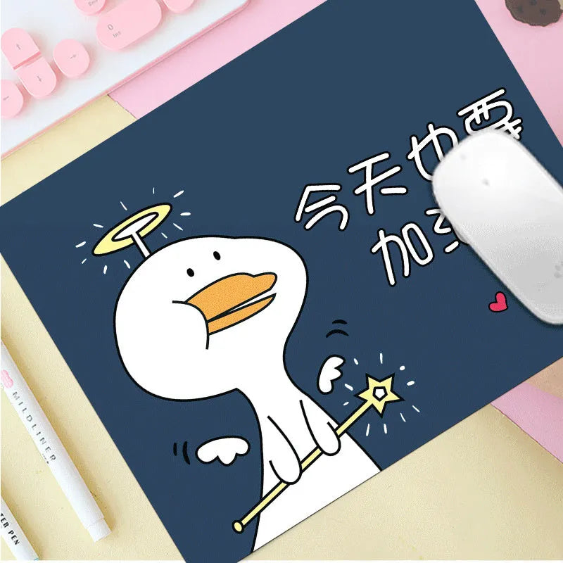 Custom cartoon design on a small black thickened mouse pad with stitching, shown on a desk.