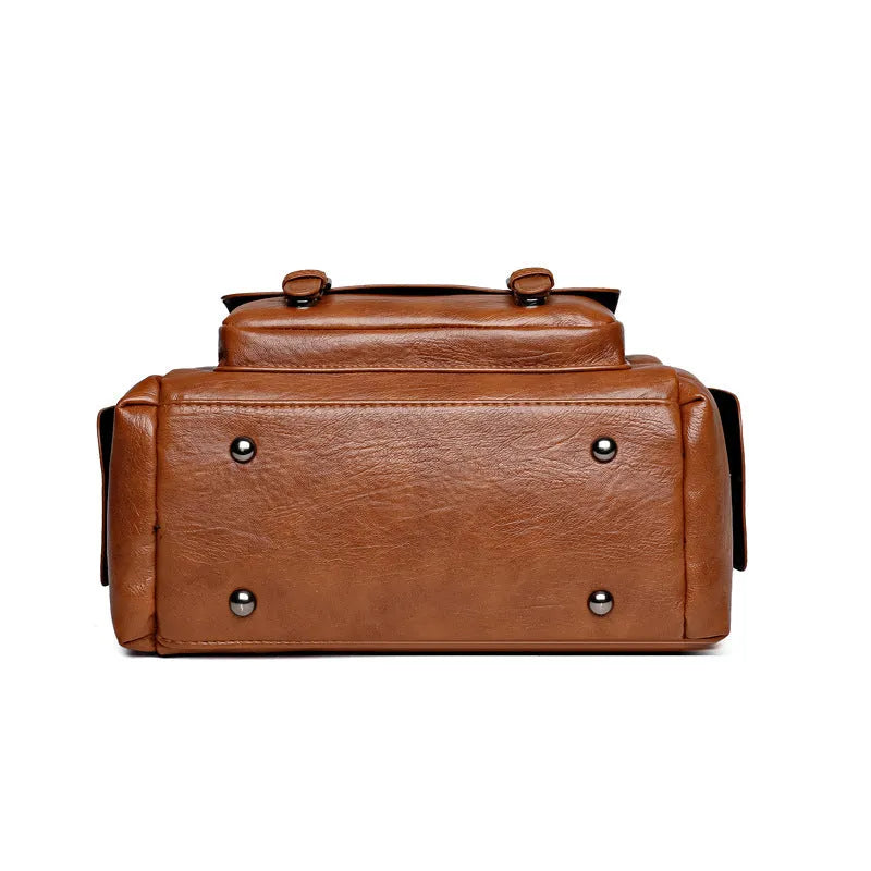 Vintage messenger bag in horizontal square shape showing stitching details and shoulder strap