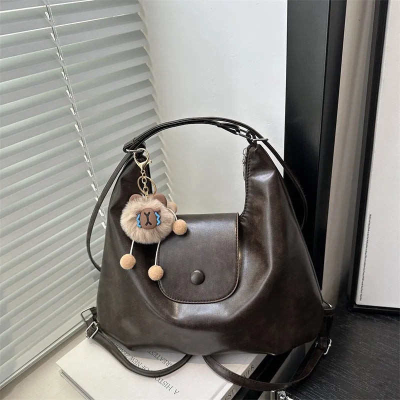 Women's PU leather shoulder bag in horizontal square shape with single strap, showing interior mobile phone compartment