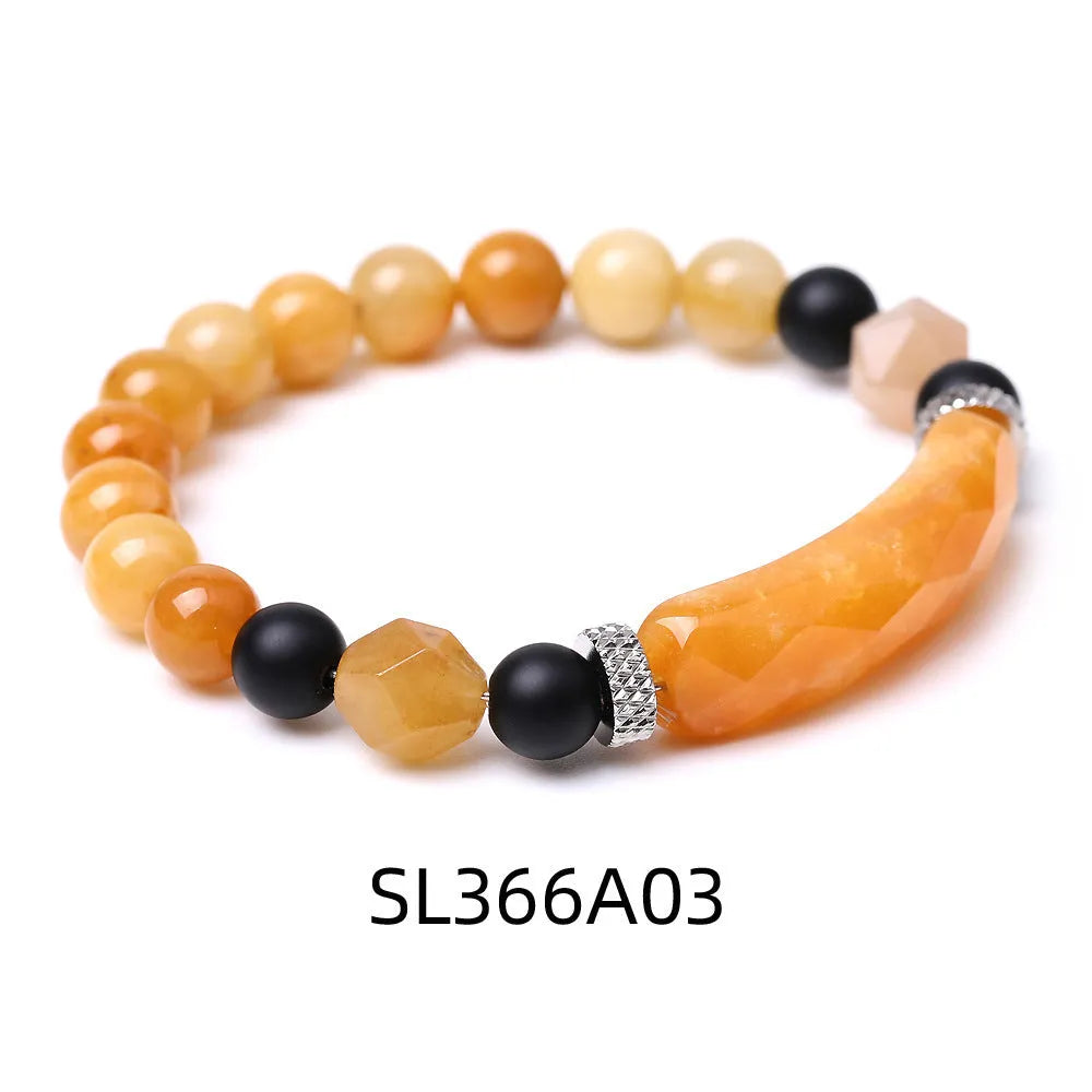 Handmade diamond-shaped cut agate bracelet in a geometric, fan-shaped design on a wrist.