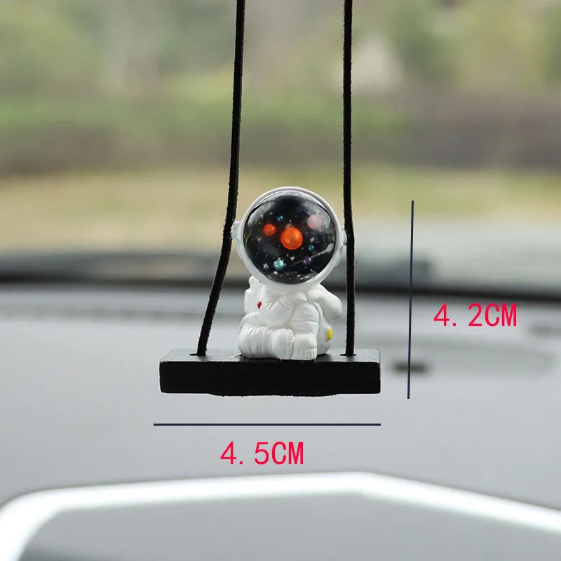 Resin cartoon astronaut car pendant available in red flag, telescope, and radish holding styles for dashboard decoration.