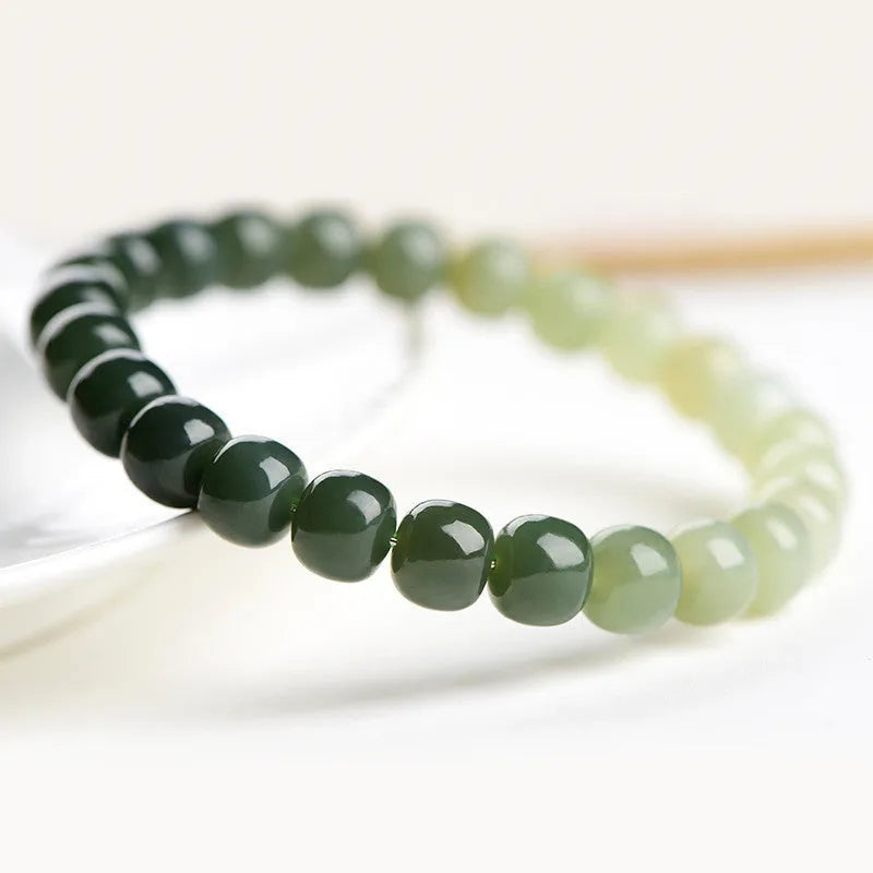 Natural Hetian jade bracelet showing water gradient colour on polished beads.