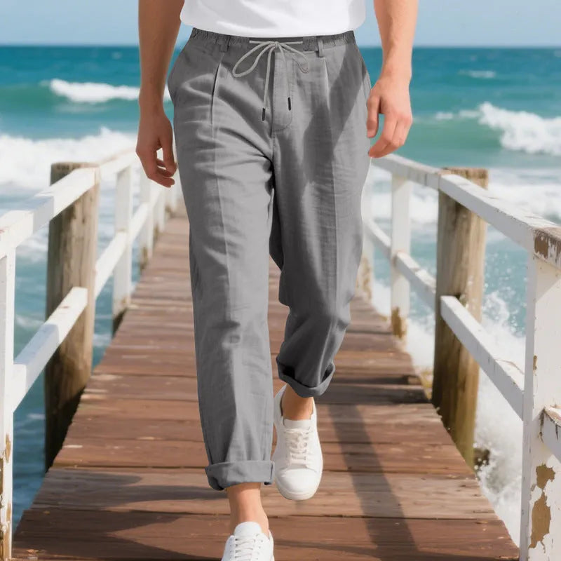 Men's light khaki linen casual trousers with a drawstring waist and straight-leg fit on a hanger.