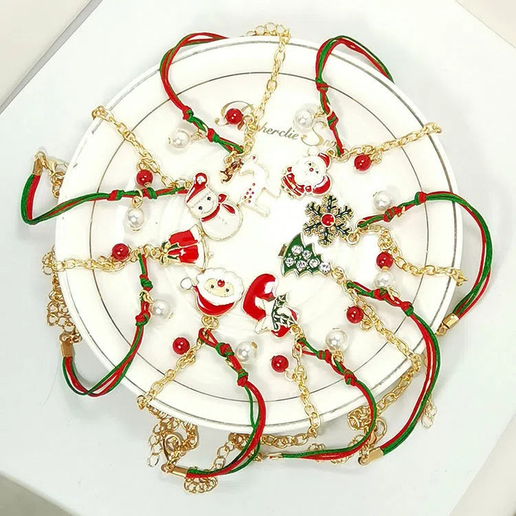 Christmas charm bracelet with alloy chain and festive pendant charms on light background