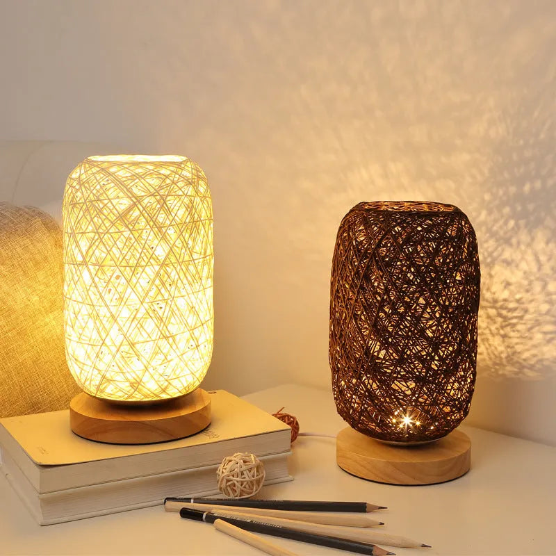 Handmade brown hemp rope spherical desk lamp with a solid wood base on a desk.