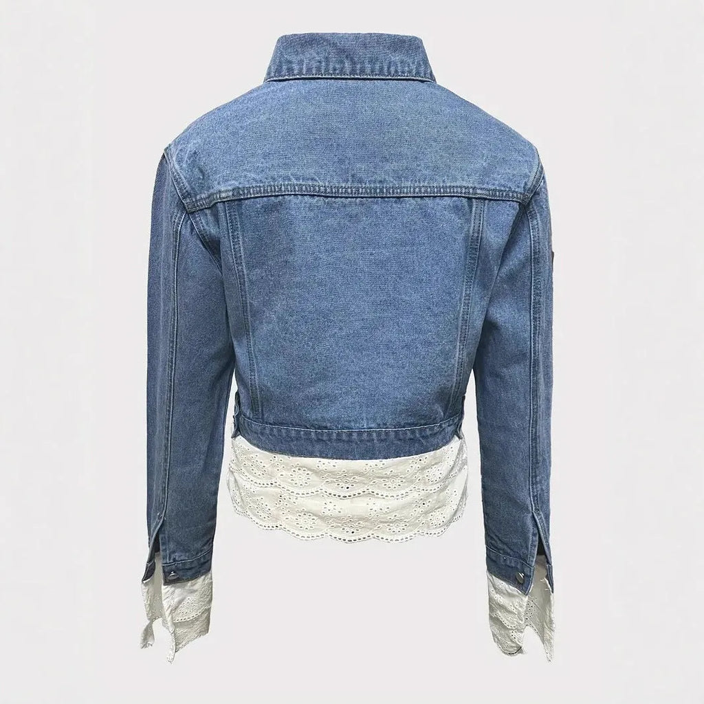 Blue women's denim jacket with lace stitching detail on the front, long sleeves.