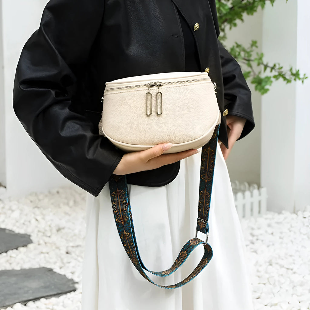 Women's soft PU leather messenger bag in saddle shape with cross-body strap, shown in green colour.