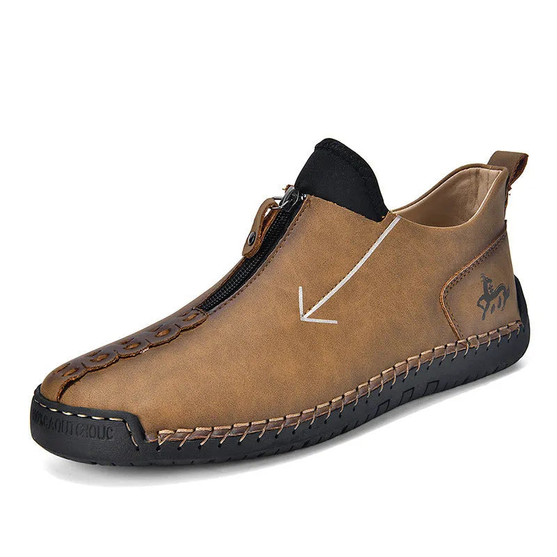 Men's black front-zip casual boots with round toe and low heel, showing the side zipper and rubber sole.