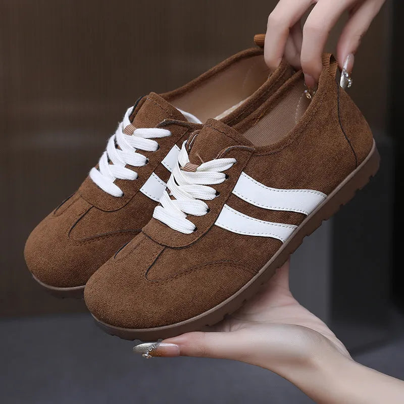 Women's vintage-style canvas sneakers with round toe and flat rubber sole in dark red.