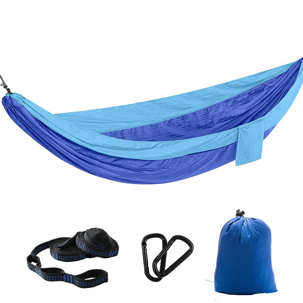 Double camping hammock with ropes and buckles shown in outdoor setting