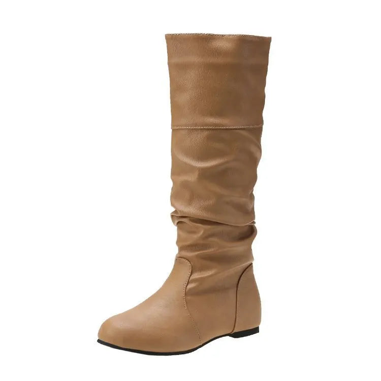 Women's black flat slip-on boots with round toe and high ankle shaft.