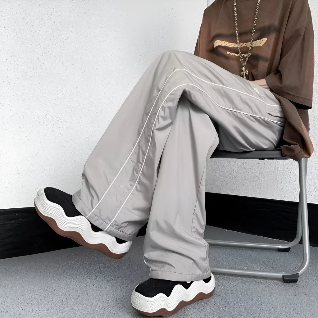 Men's navy blue wide leg striped casual pants made from lightweight polyester fabric, suitable for summer