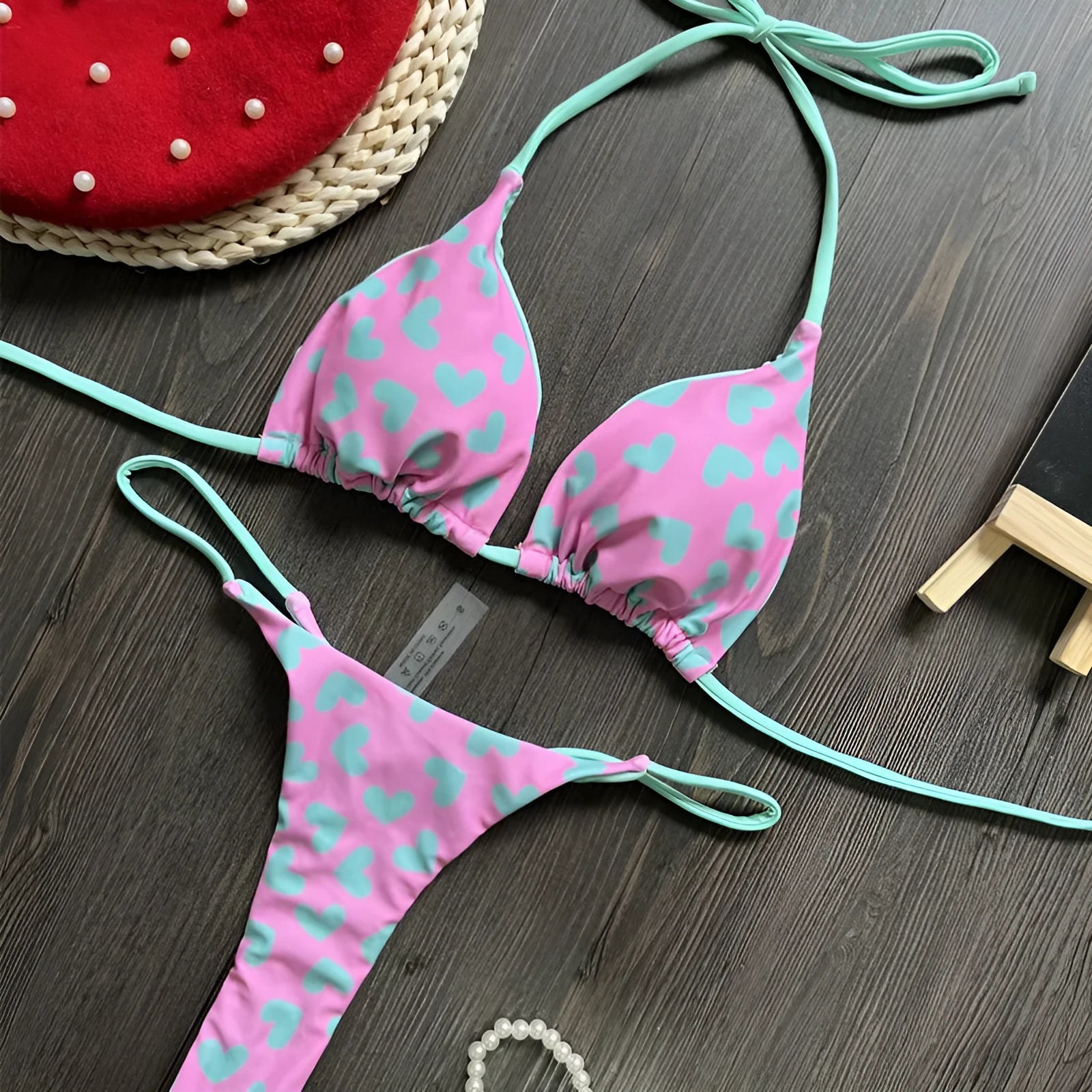 Heart print backless two-piece swimsuit with high-cut legs and split sides on a mannequin