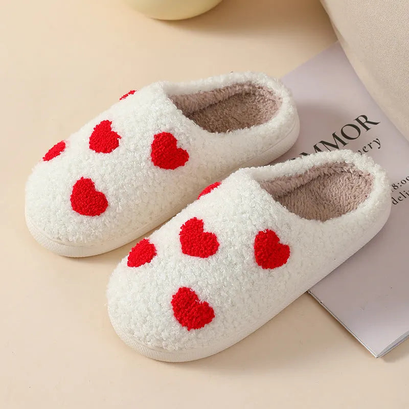 Women's plush cartoon love style home slippers with a non-slip PVC sole.