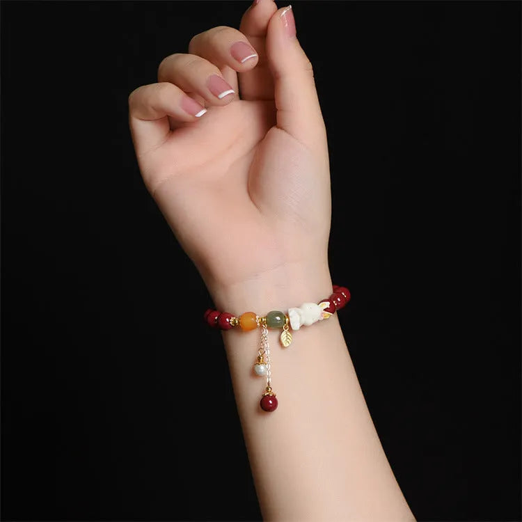 Traditional Chinese cinnabar bracelet with rabbit design, available in 8mm and 10mm bead sizes.
