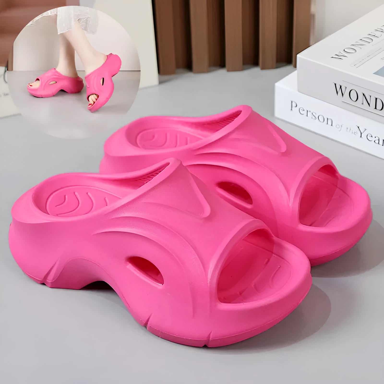 Women's white thick-soled EVA slippers with rounded toe on a sandy beach.