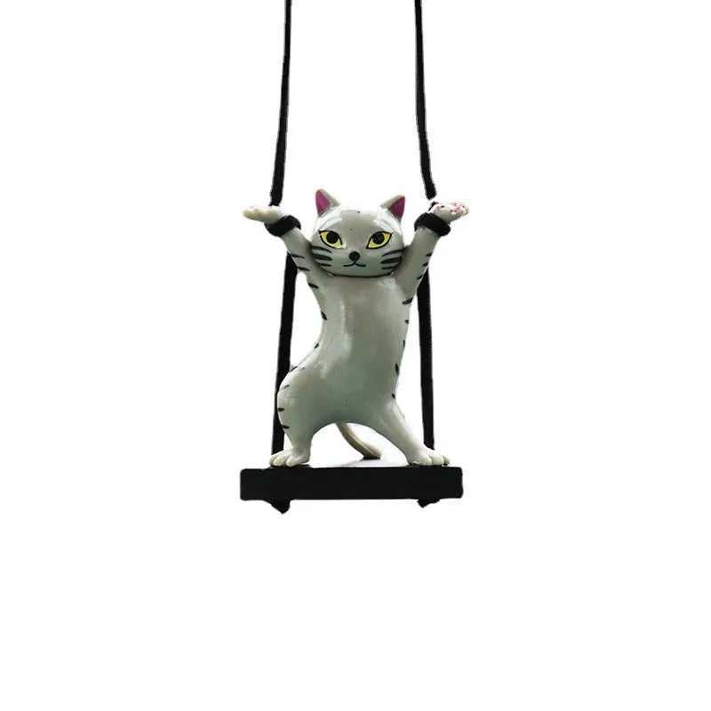 Resin cartoon cat pendant for car interior decoration on adjustable rope.