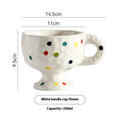 Hand-pinched irregular shaped ceramic mug in solid colour with modern simplicity design