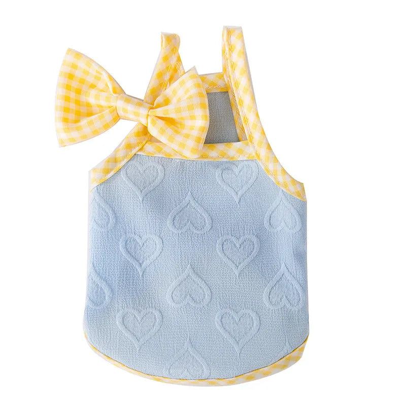 Small dog wearing heart bow suspenders vest in elastic material with decorative bow detail