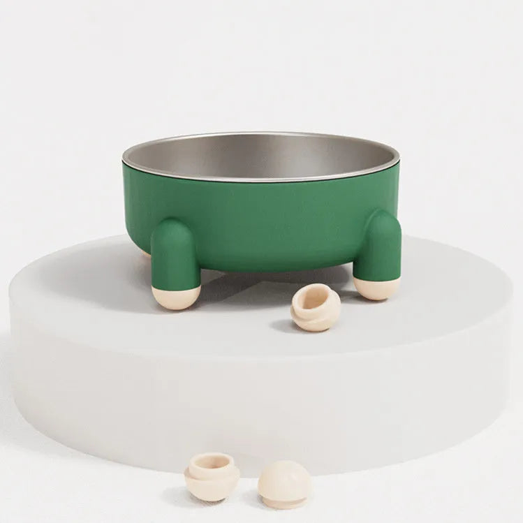 Green stainless steel pet bowl with a high foot and non-slip base on a kitchen floor.