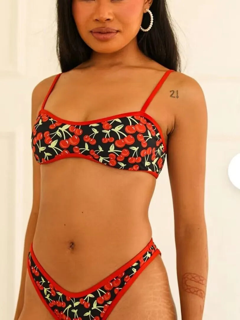Women's cherry print tube top bikini swimsuit in brief style on a mannequin.