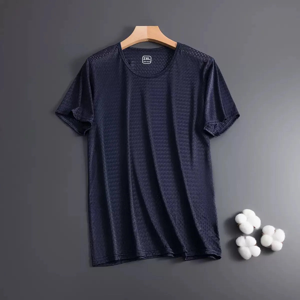 Man wearing a thin grey Ice Silk short sleeve crew neck t-shirt with a loose fit.