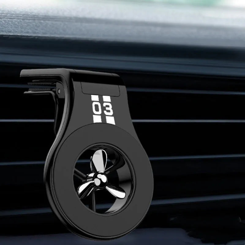 Black universal magnetic car phone holder clipped to a car air vent, holding a smartphone.
