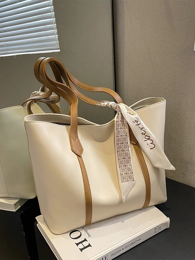 Women's soft large tote bag in a chosen colour, showing outer pockets and sewing detail.