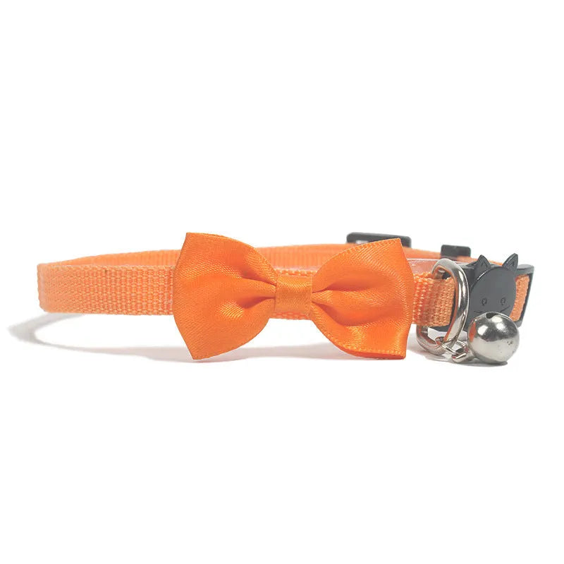 Adjustable striped nylon cat collar with a bell shown in multiple colours including red, blue, green, and pink.
