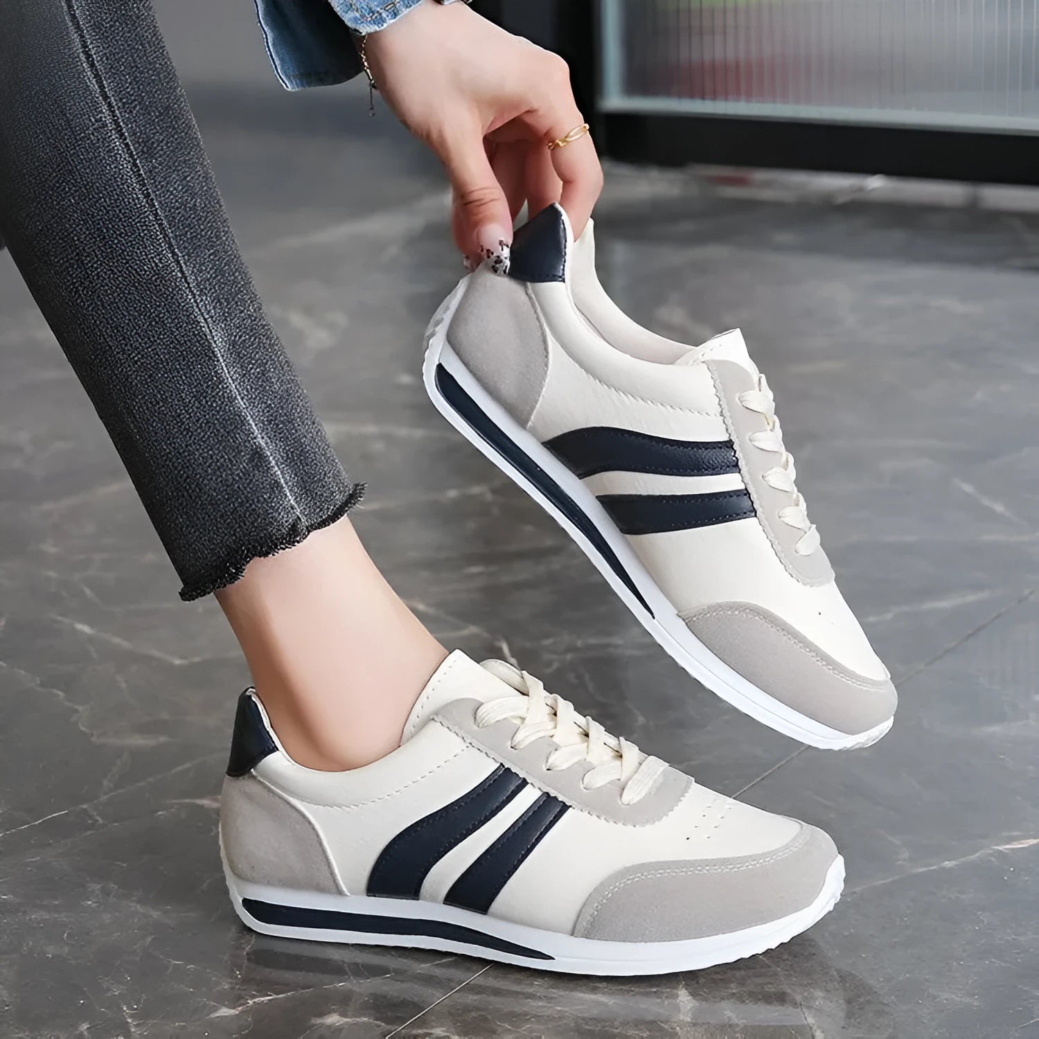 Red and blue lace-up low-top running sneakers with mesh upper and rubber sole on a white background.
