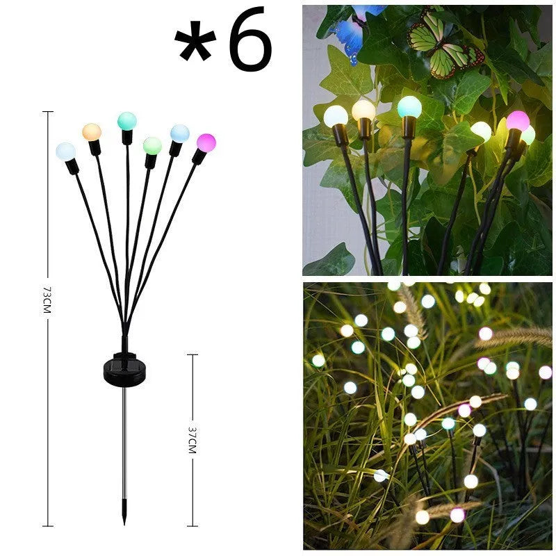 Solar-powered LED firefly lawn light with ground stake inserted in grass