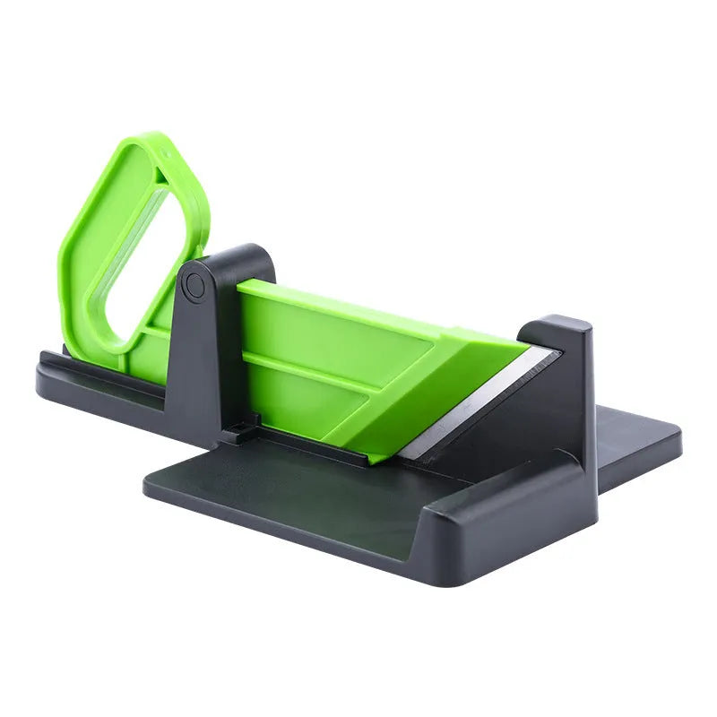 Green and red modern vegetable cutter with stainless steel blades for slicing carrots and potatoes.