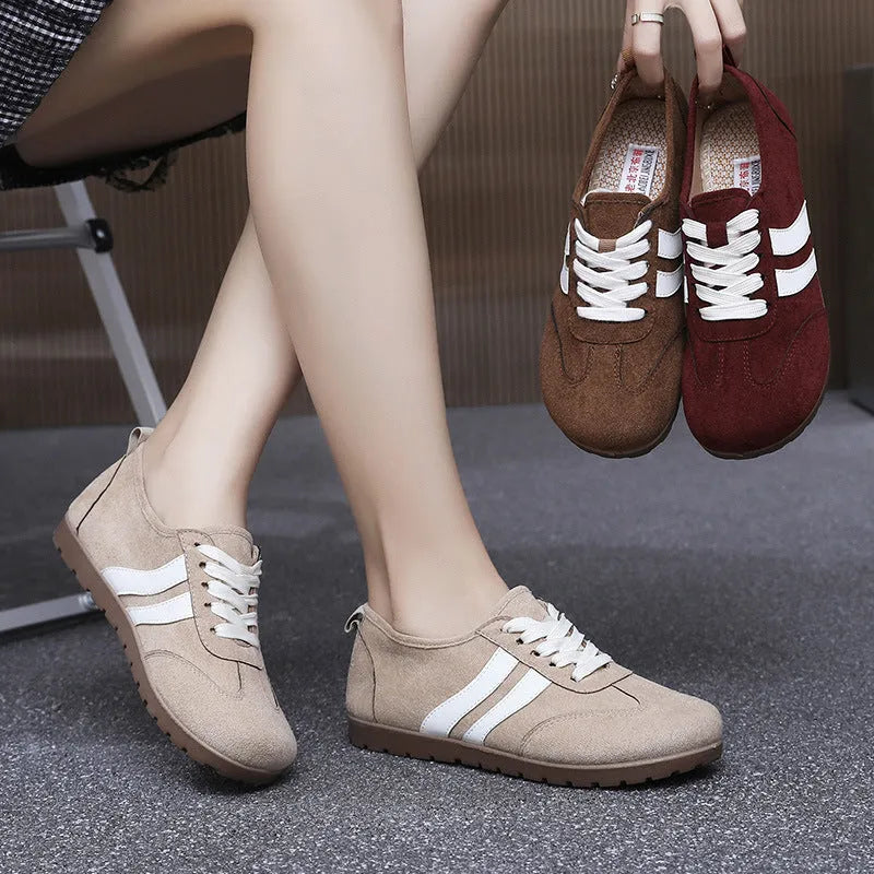 Women's vintage-style canvas sneakers with round toe and flat rubber sole in dark red.